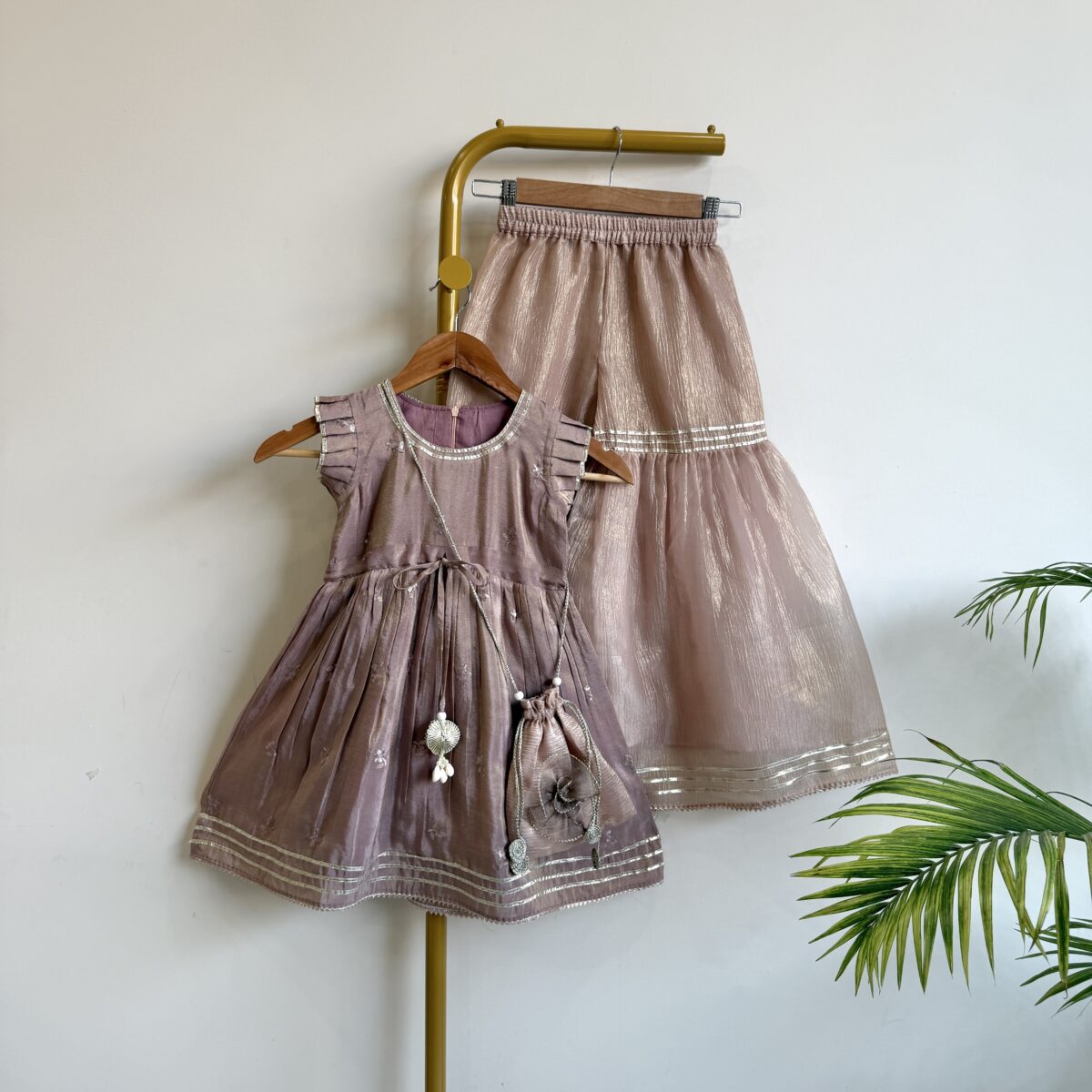 DUSTY MAUVE PEPLUM TOP AND SHIMMER SILK TISSUE SHARARA SET WITH POTLI BAG